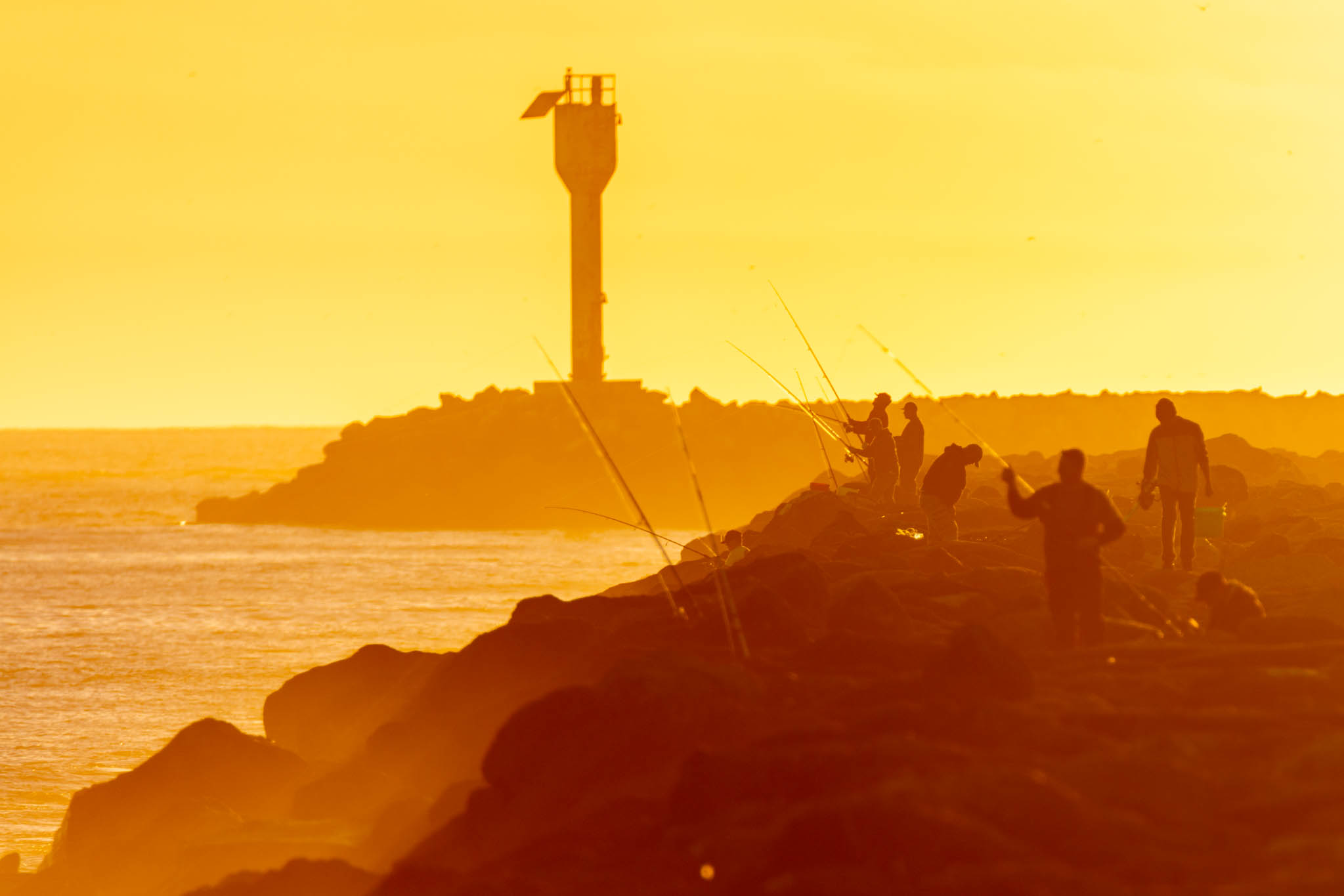 Fishing from the jetty at sunset.