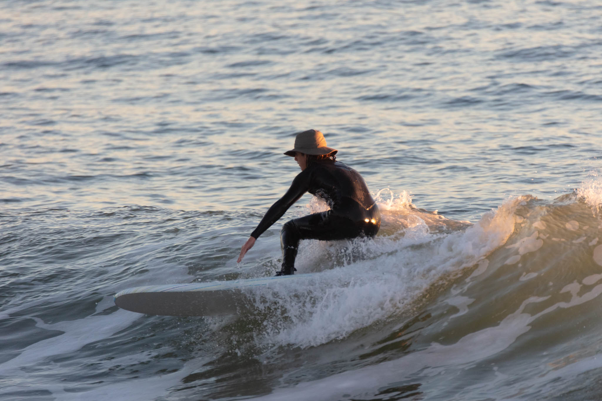 A surfer rides the waves at Surfer