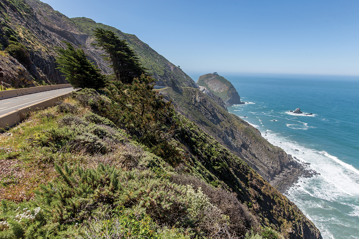 Hikers enjoying the panoramic ocean views from Devil's Slide Trail with proper hiking gear