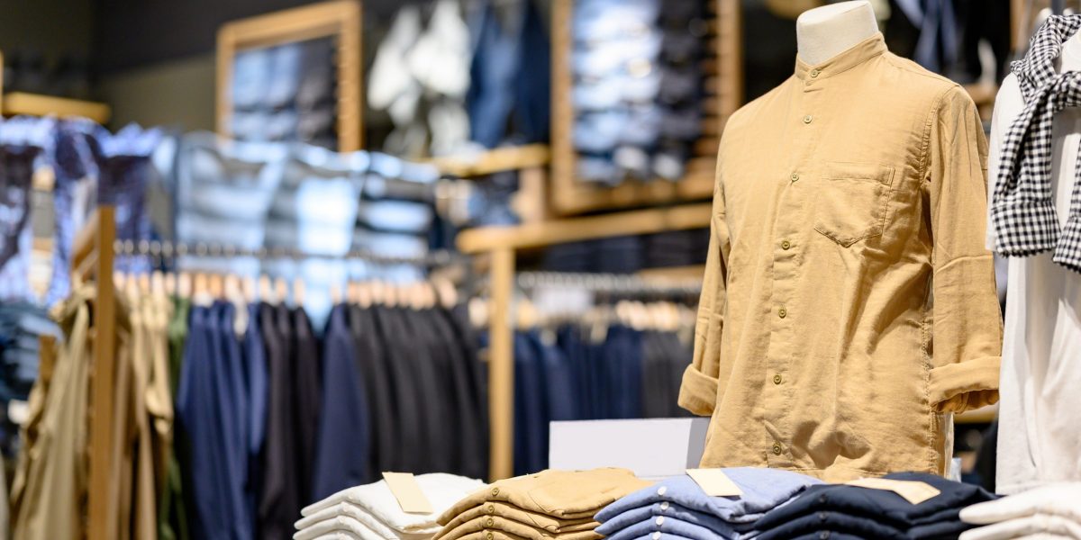 Trendy cotton Men shirt display on mannequin in clothes shop. Summer collection fashion product samples in clothing store for selling. Textile industry and business concept