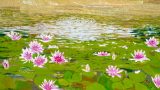 Pink water lilies floating on green lily pads across a pond with bright reflections on the water.